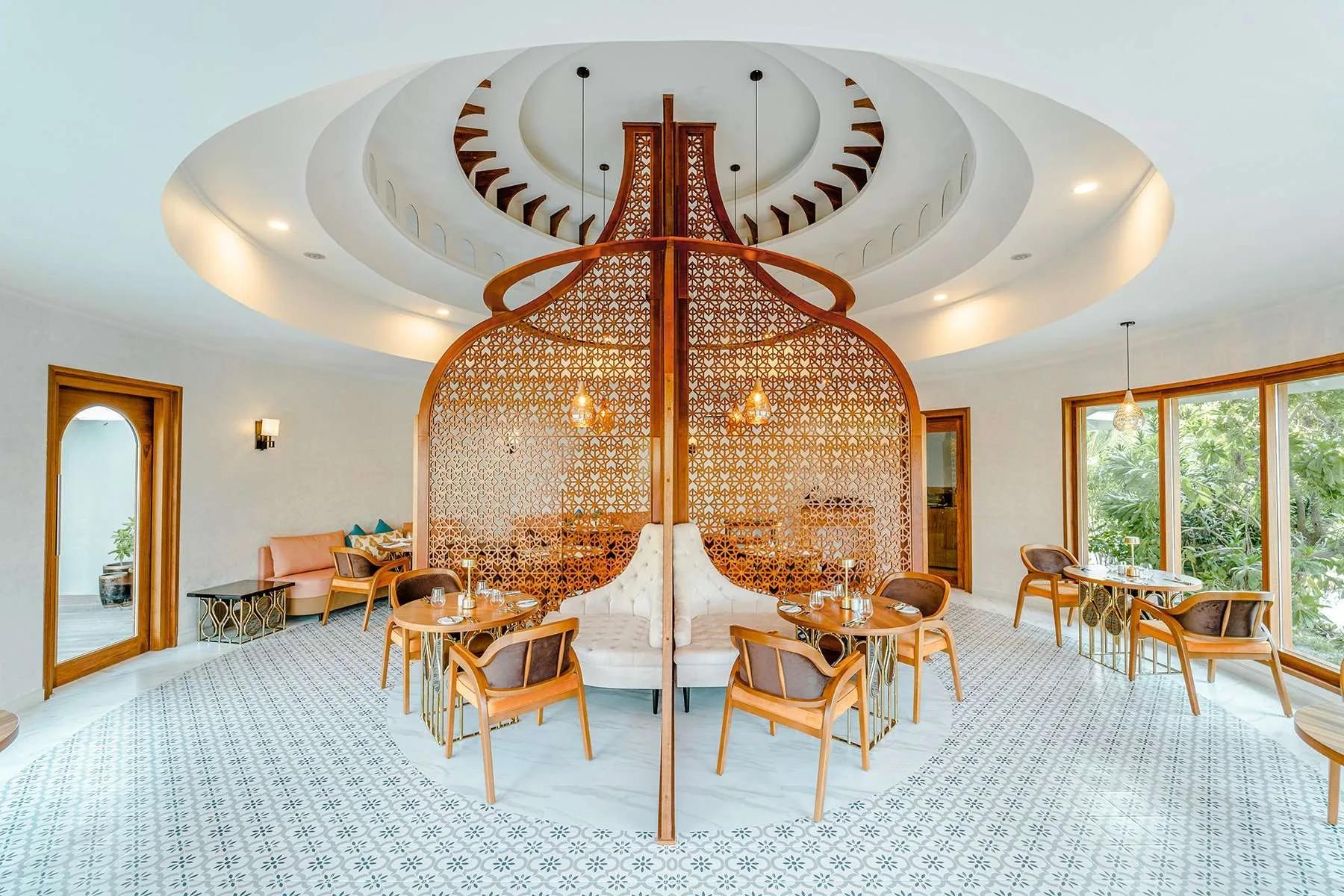 Interior lounge seating at Oasis Restaurant, Bar & Lounge, an ornate wood screen at its centre