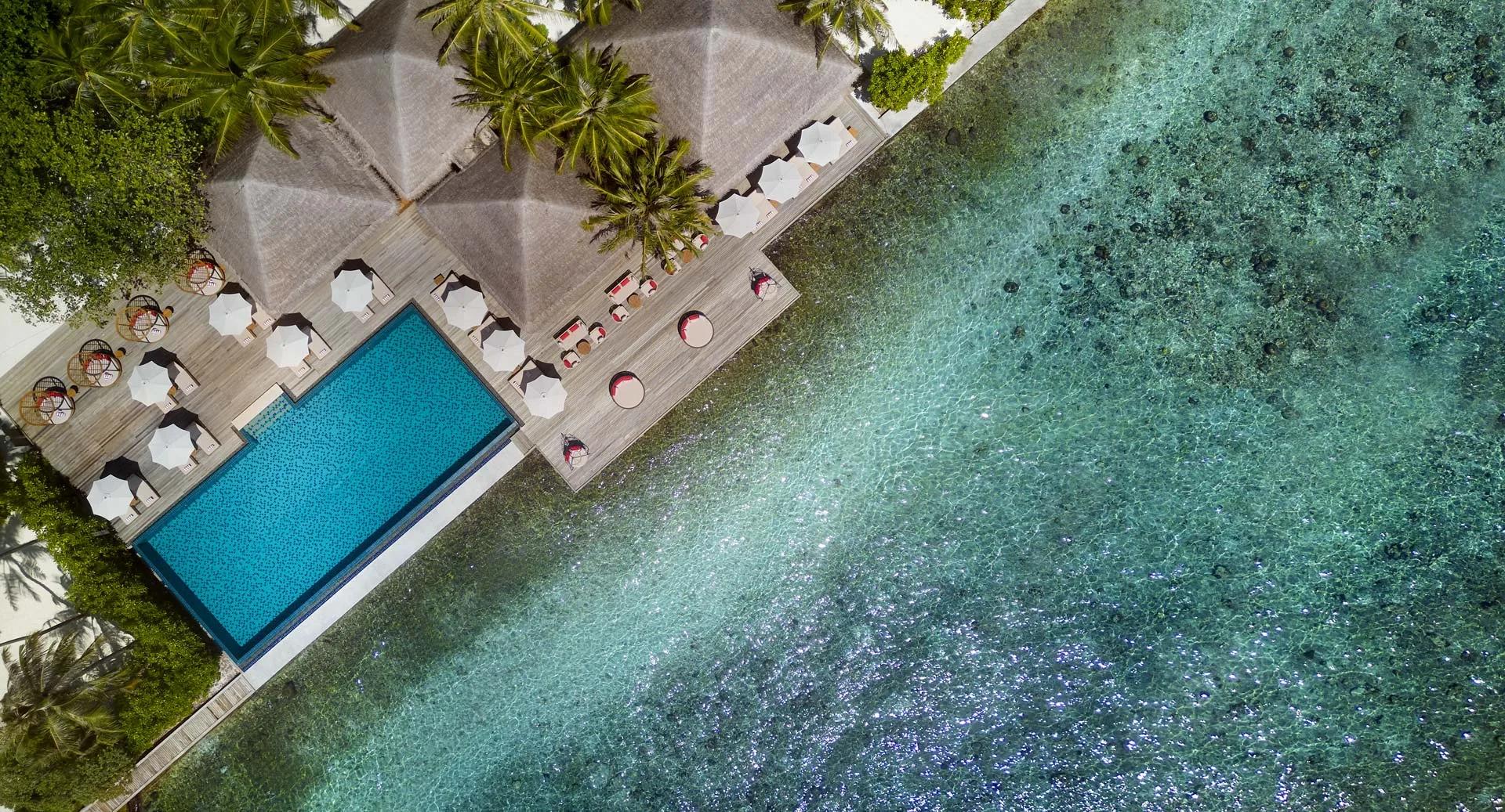 Aerial view of the infinity pool deck at Dhoni Bar, built out over the lagoon reef