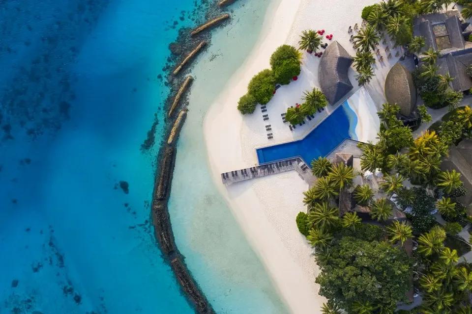 Aerial view of Kuramathi's main pool and beachfront pavilions near the island's dining quarter — no dedicated Island Coffee Shop photograph was available in the research set
