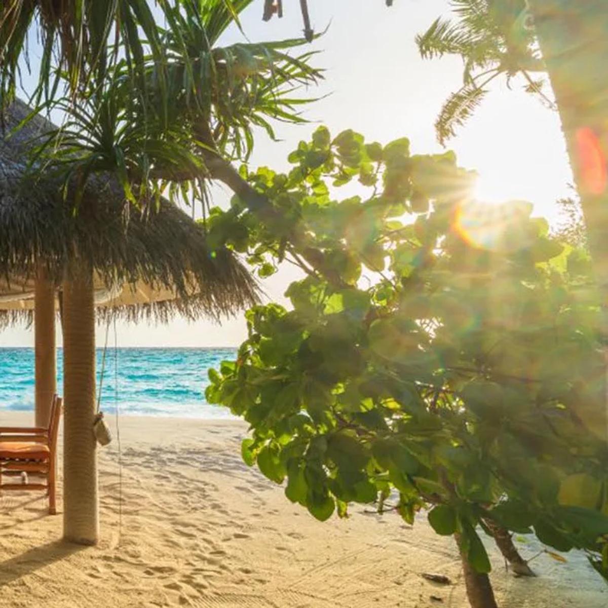 Shoreline Grill's beachfront pavilion at Milaidhoo, set for dinner.