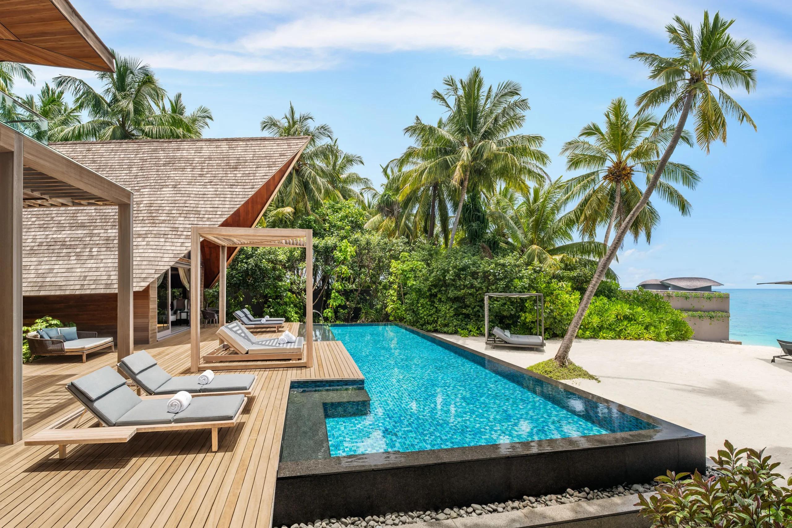 The exterior and private pool deck of the Knickerbocker Villa, a two-bedroom beachfront signature villa