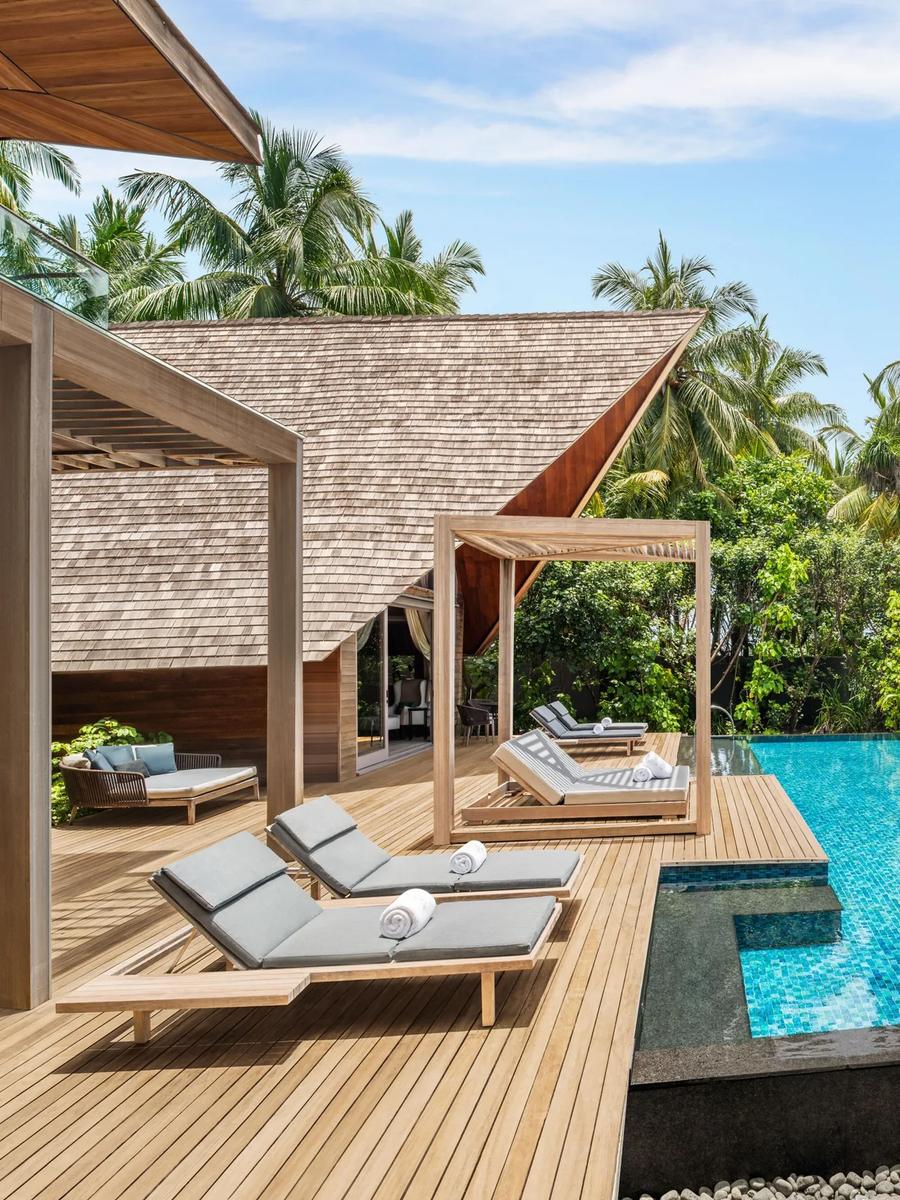 The exterior and private pool deck of the Knickerbocker Villa, a two-bedroom beachfront signature villa