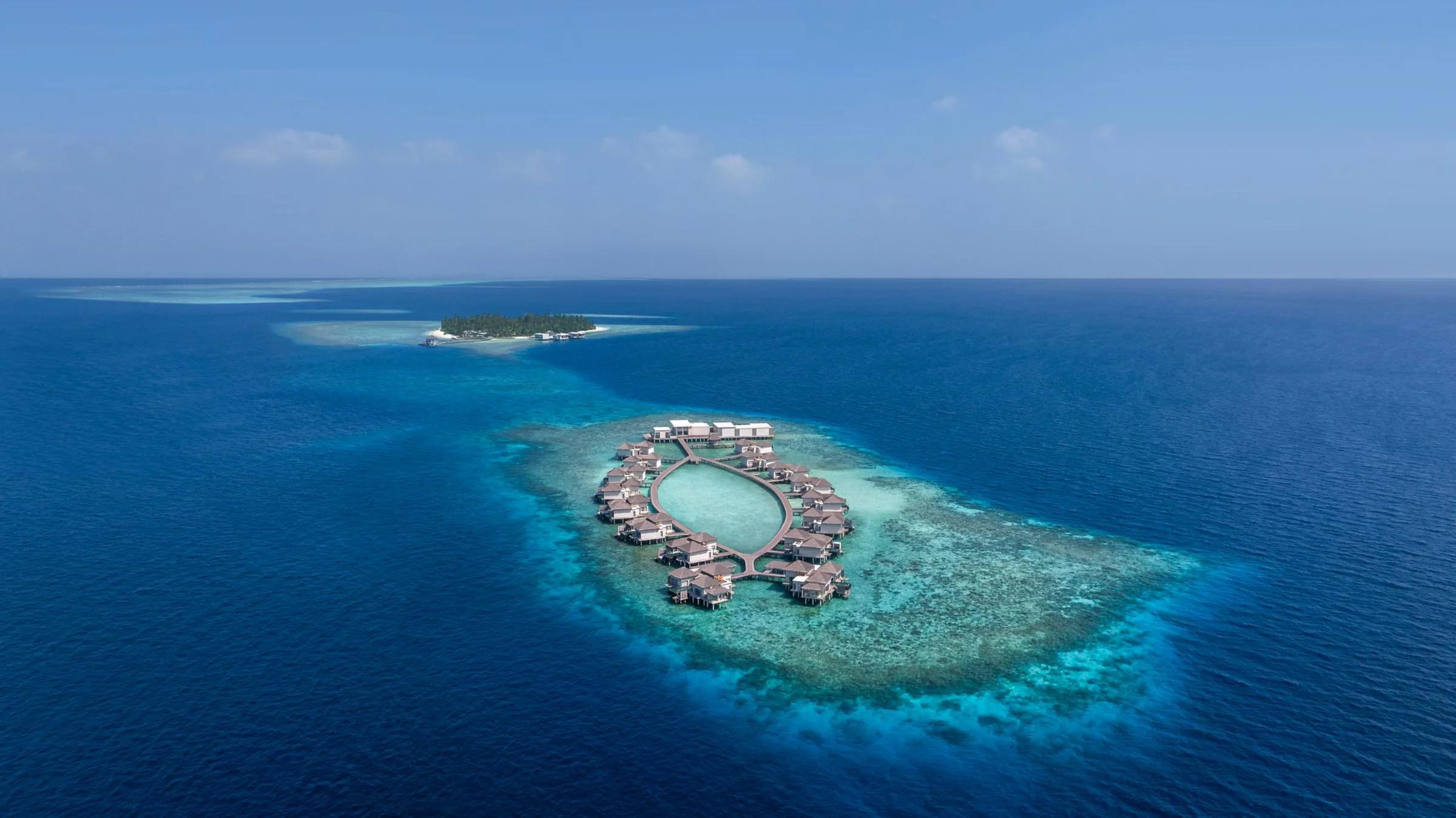 Halcyon's two connected private isles seen from above, joined by a jetty