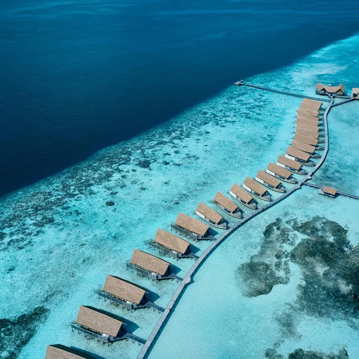 A directly overhead view of the villa jetty zigzagging across the reef flat between deep water and lagoon