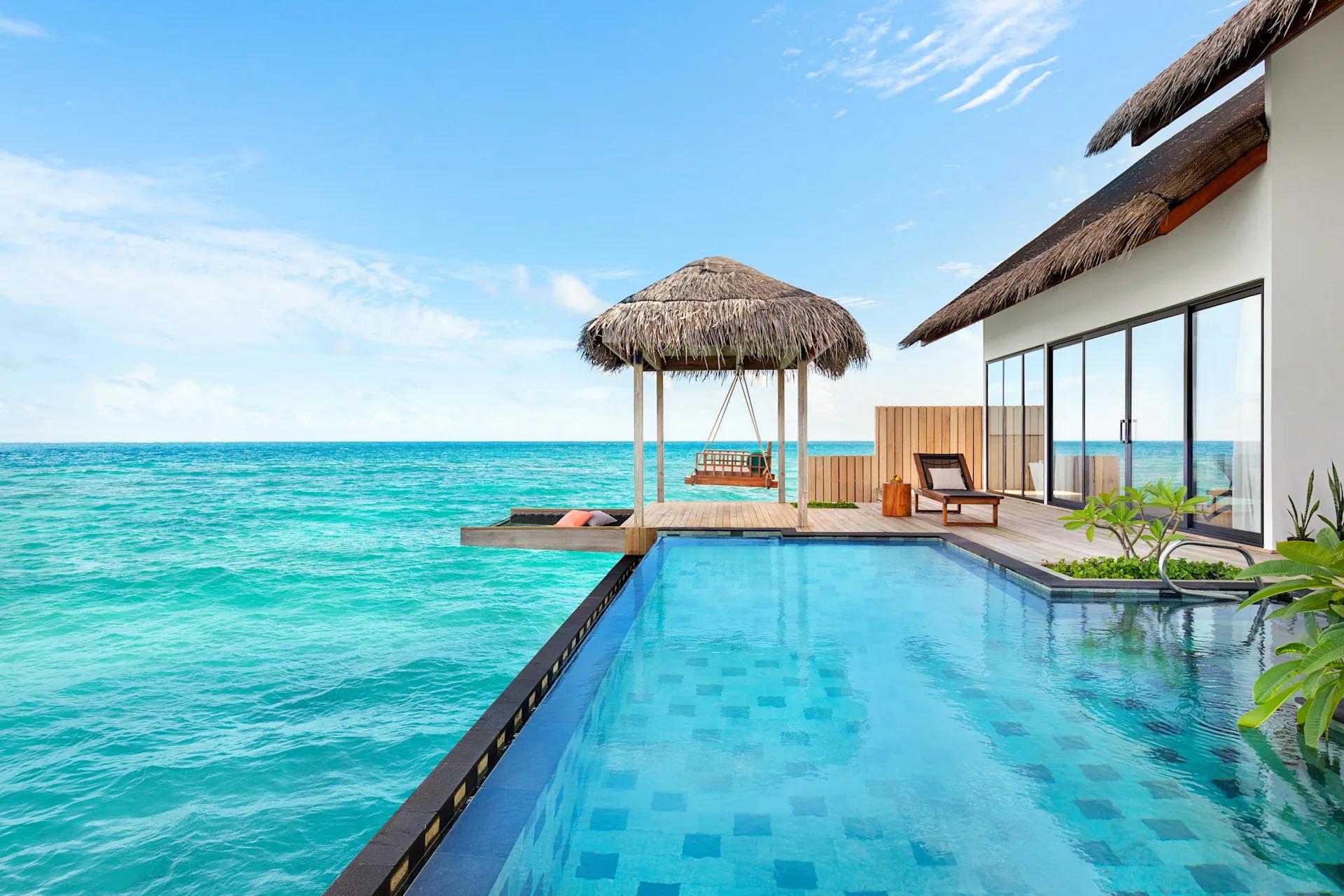 The exterior of a Two Bedroom Overwater Pool Villa, its private pool and deck stretching over the lagoon