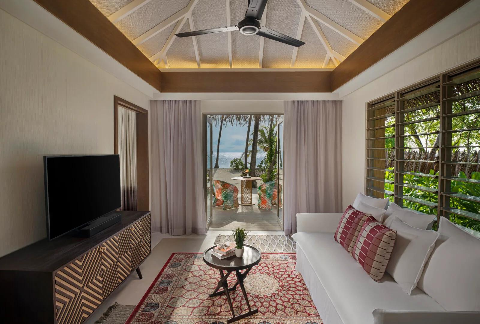 The living area of a Family Beach Pool Villa, opening onto its beachfront terrace