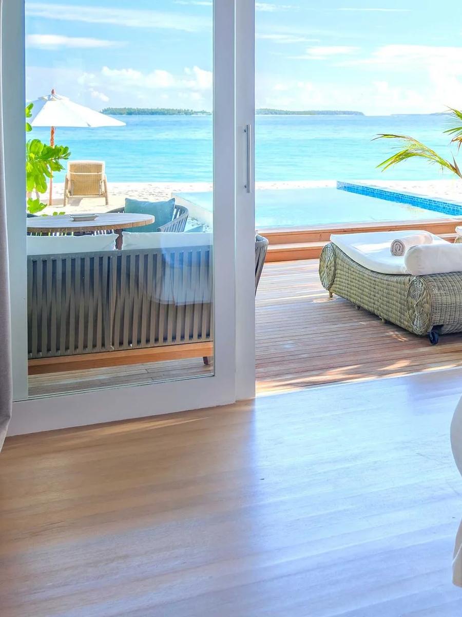 A Sunset Beach Villa with Pool's bedroom opening onto its private plunge pool and beachfront sun loungers