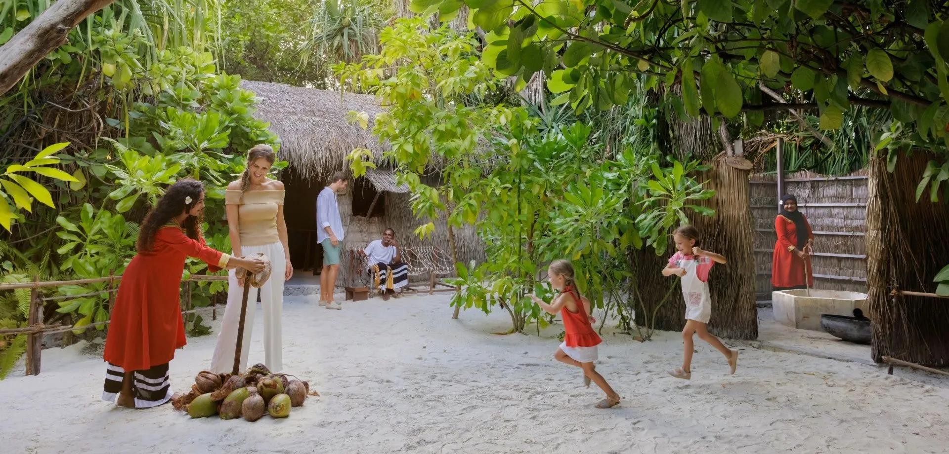 Thatched-roof buildings of the Living Maldivian Village experience at Heritance Aarah