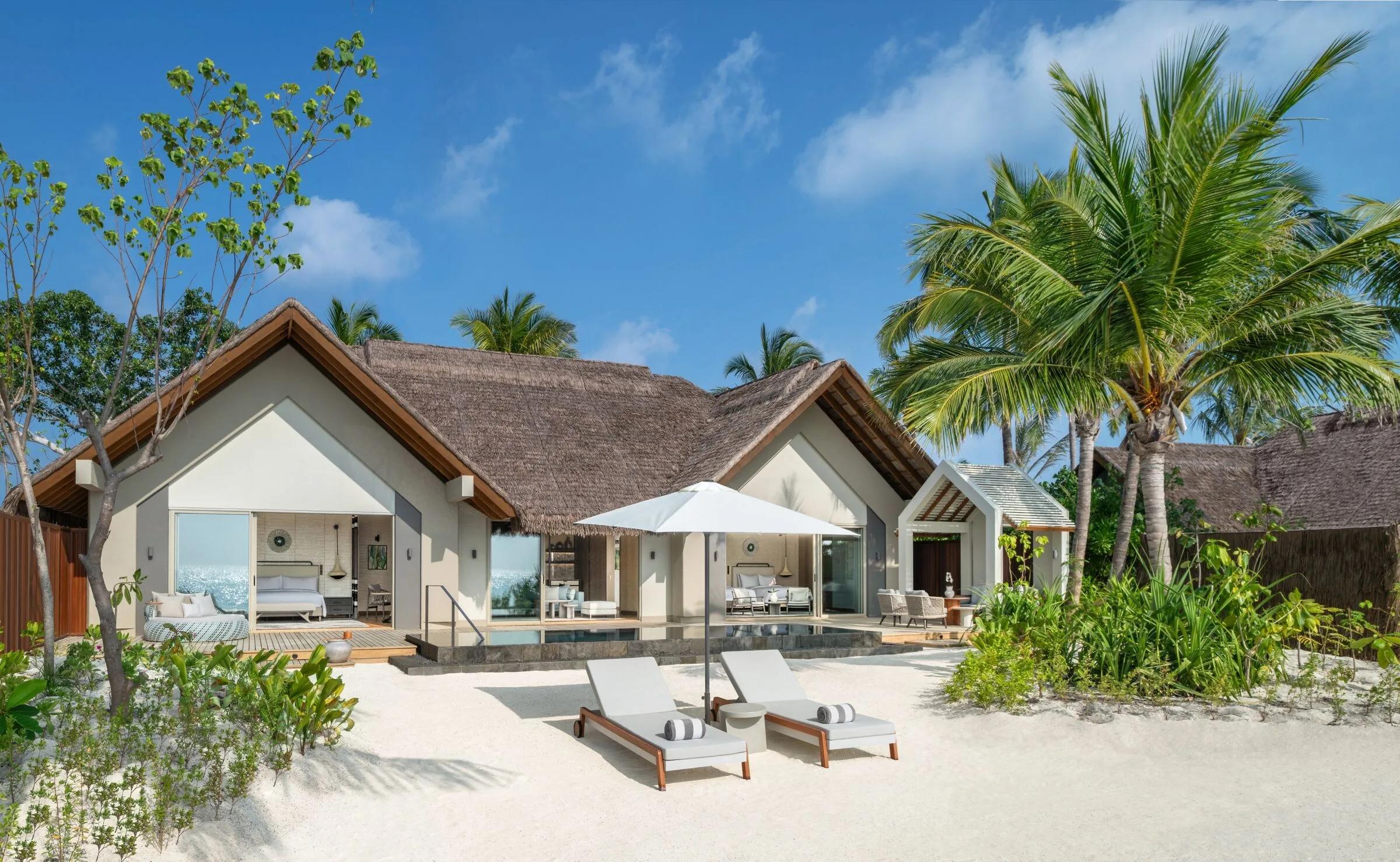 The exterior of a Beach Pool Villa set among palms