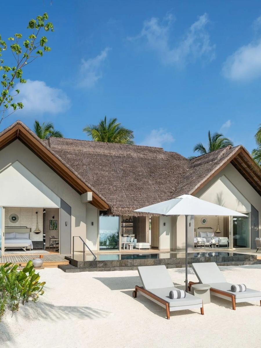 The exterior of a Beach Pool Villa set among palms