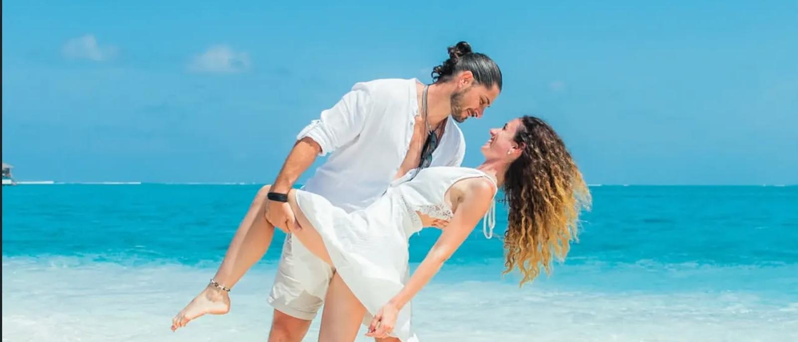 Romantic Maldives overwater villa at sunset for honeymooners