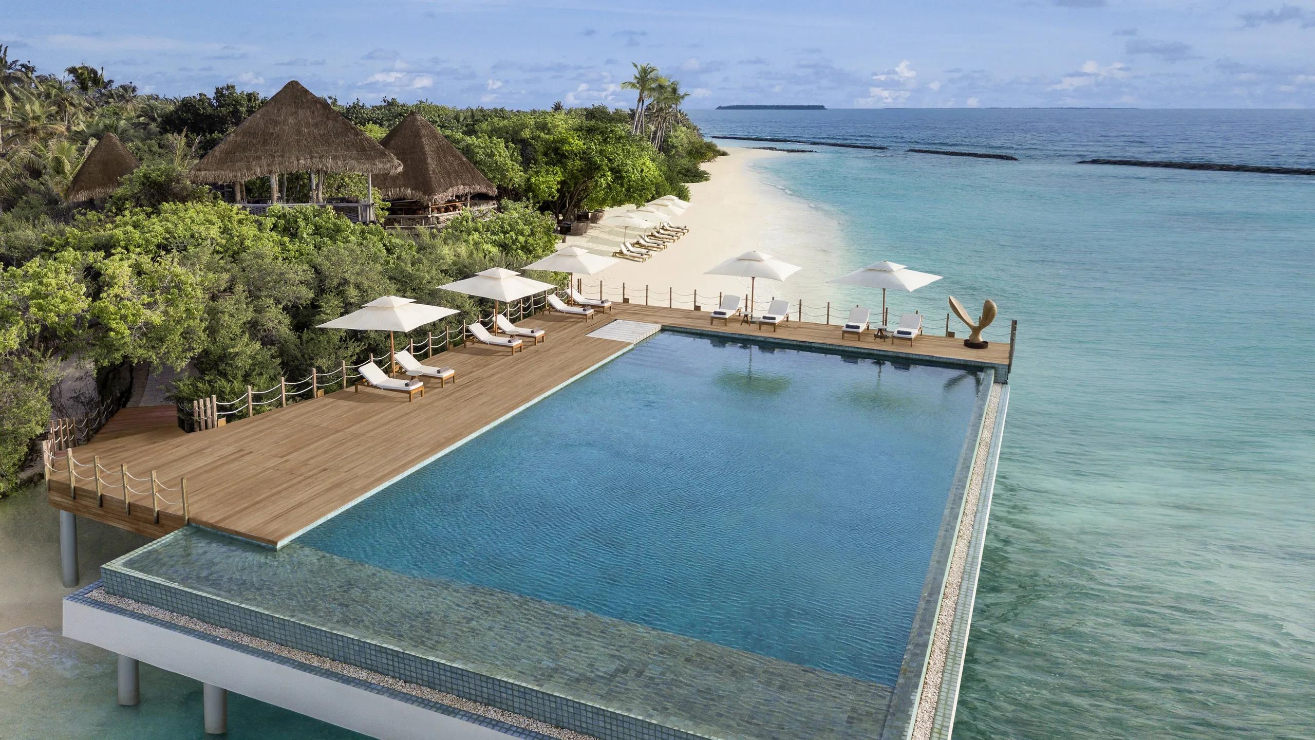 Pool 18, the resort's adults-only infinity pool, extending out over the lagoon at the island's edge