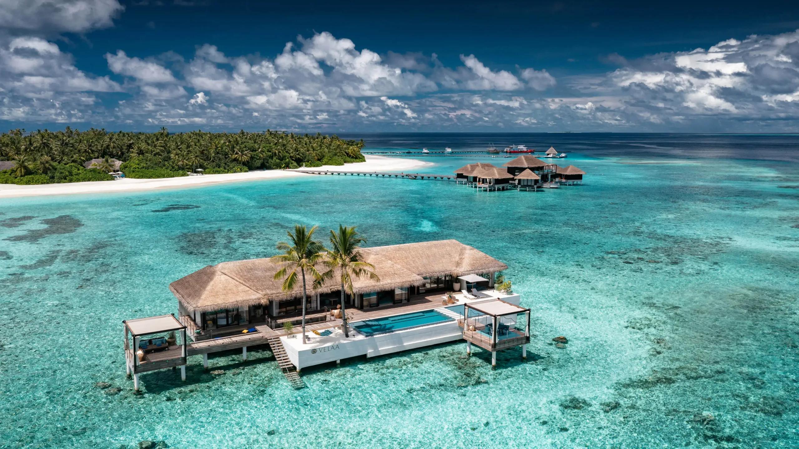 The Romantic Residence seen from above, a standalone overwater villa reached by boat, its pool and sun deck over the lagoon