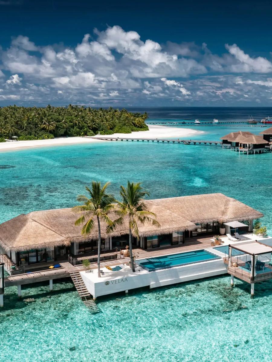 The Romantic Residence seen from above, a standalone overwater villa reached by boat, its pool and sun deck over the lagoon