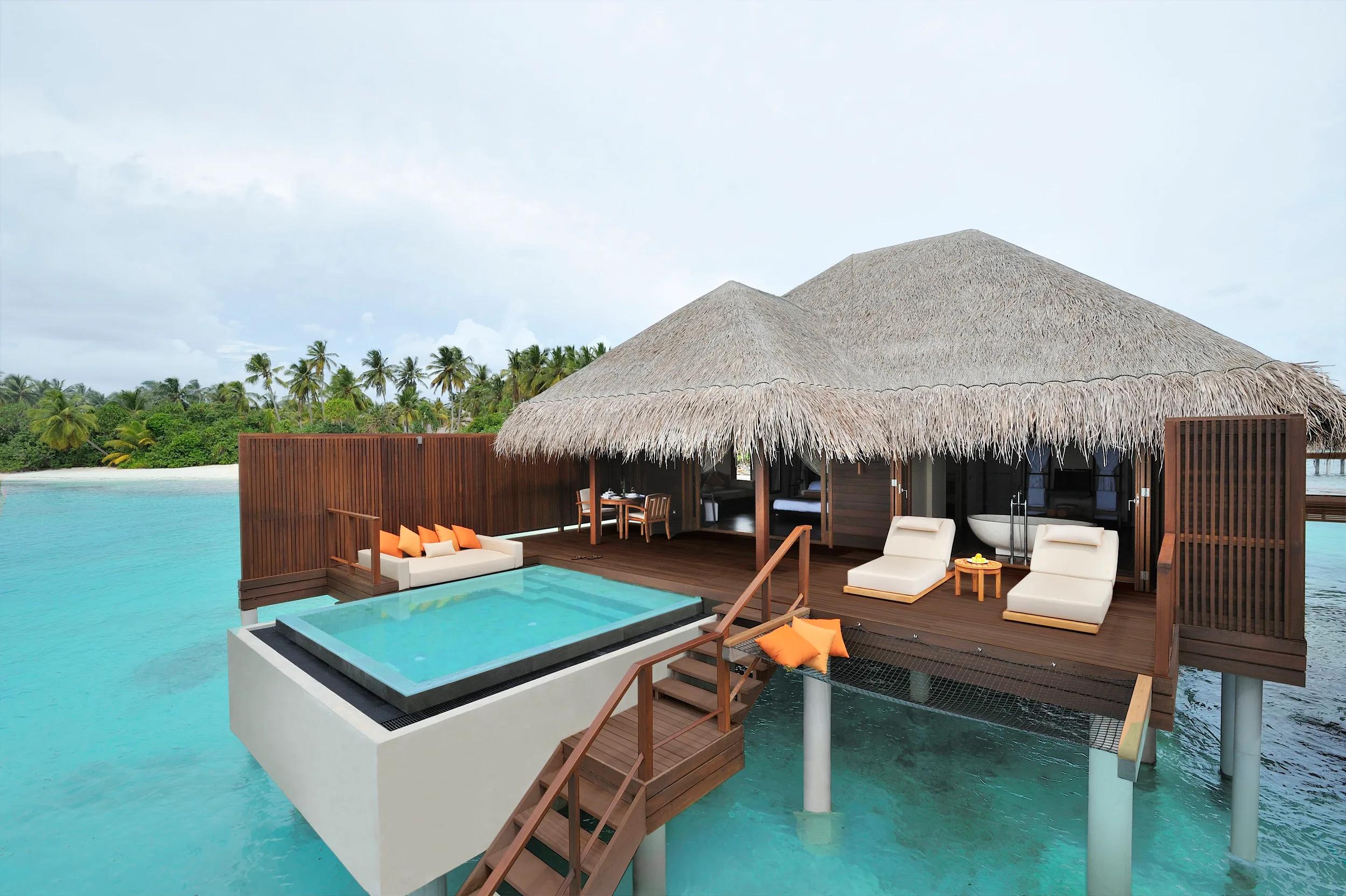 Two connected Ocean Villas on stilts over the lagoon, each with its own cantilevered plunge pool
