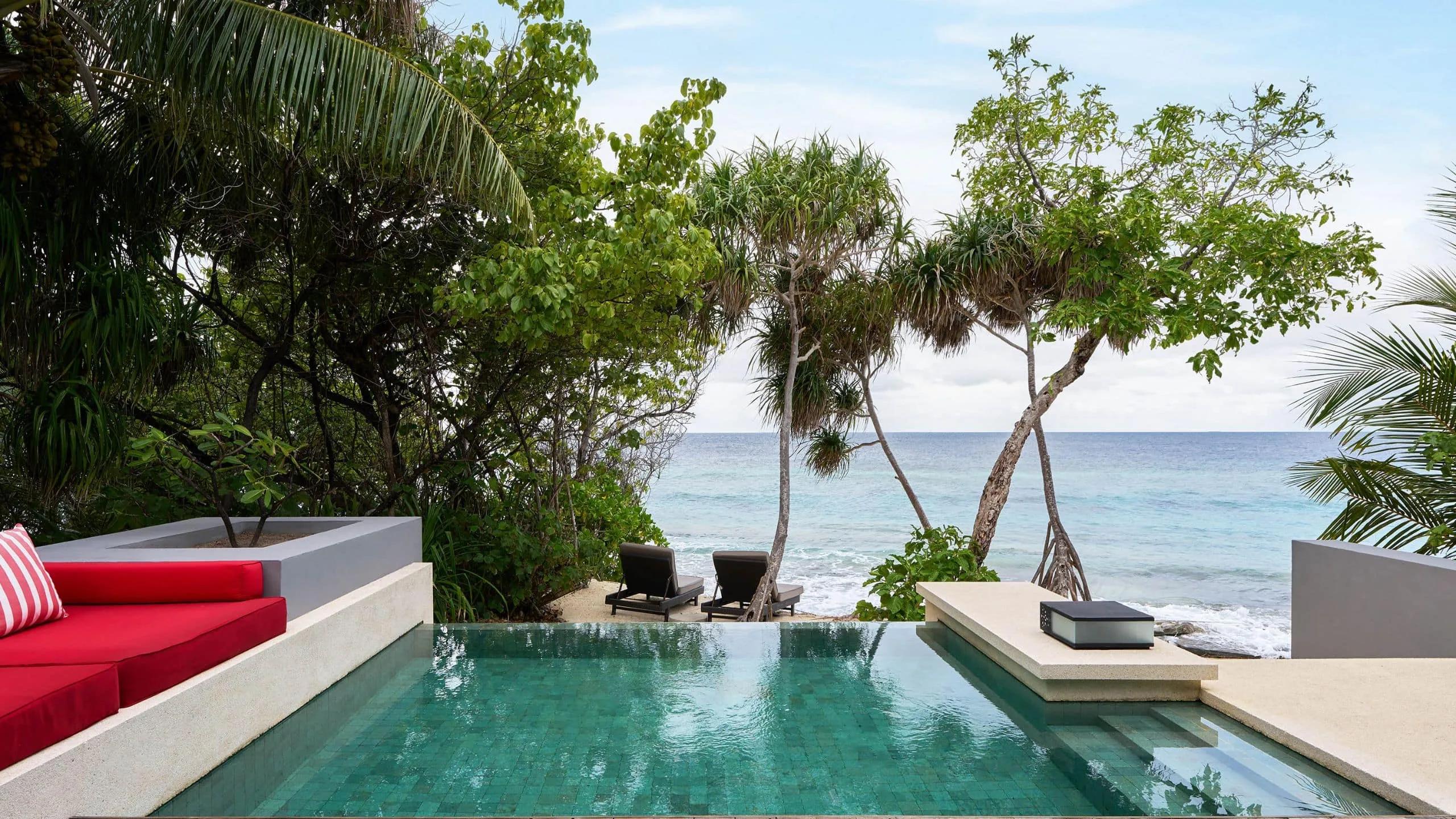 The private pool of a Beach Pool Villa, pandanus trees framing a view straight to the ocean