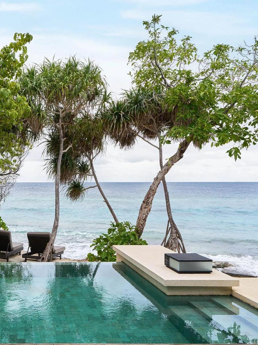 The private pool of a Beach Pool Villa, pandanus trees framing a view straight to the ocean