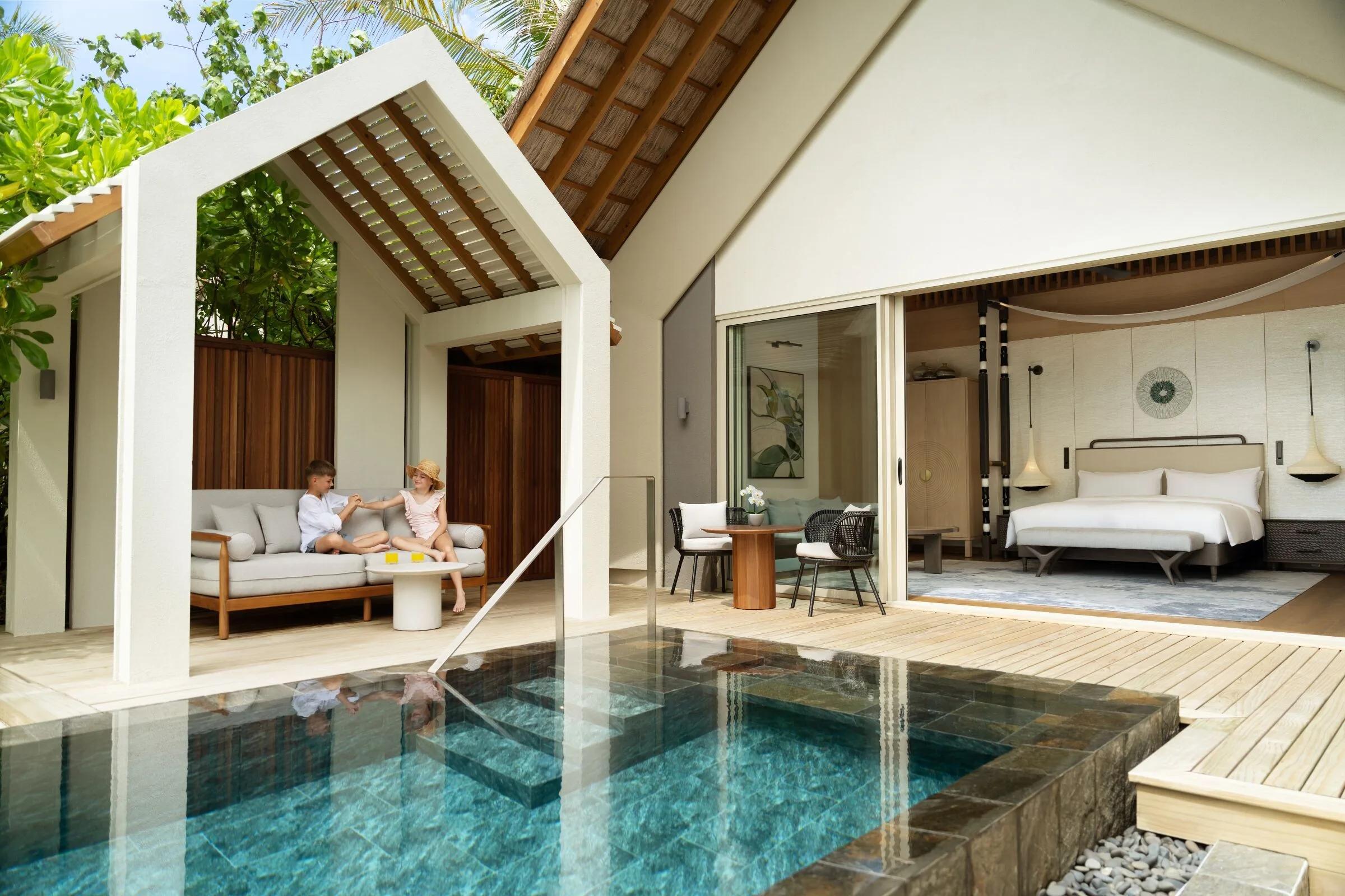 The exterior of the Family Beach Pool Villa, set among palms on Hathaa Finolhu's beach