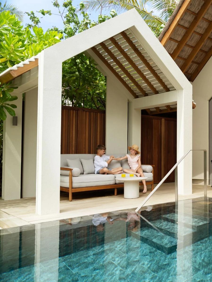 The exterior of the Family Beach Pool Villa, set among palms on Hathaa Finolhu's beach