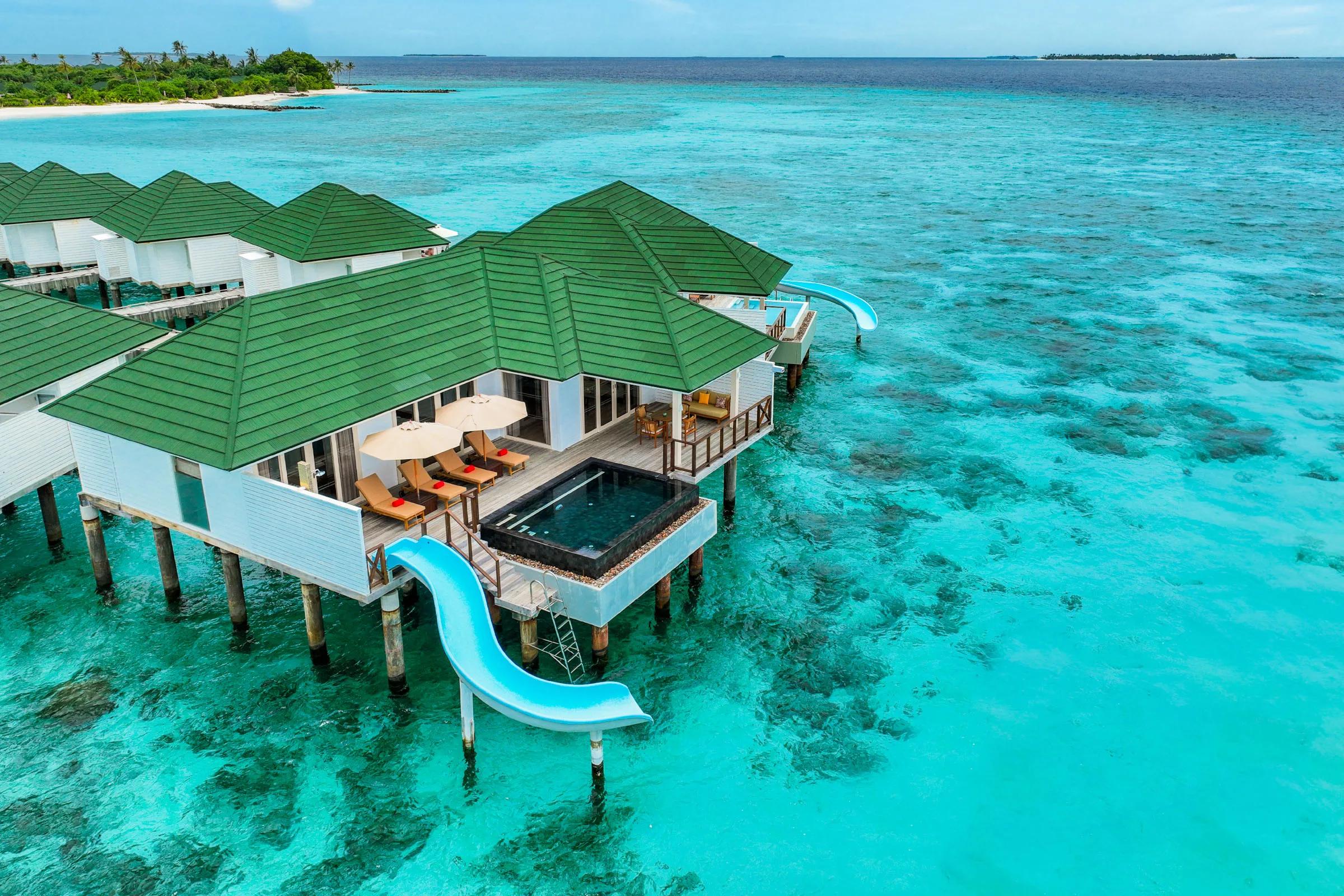 Overwater villas with pools and slides reaching into the lagoon at Siyam World