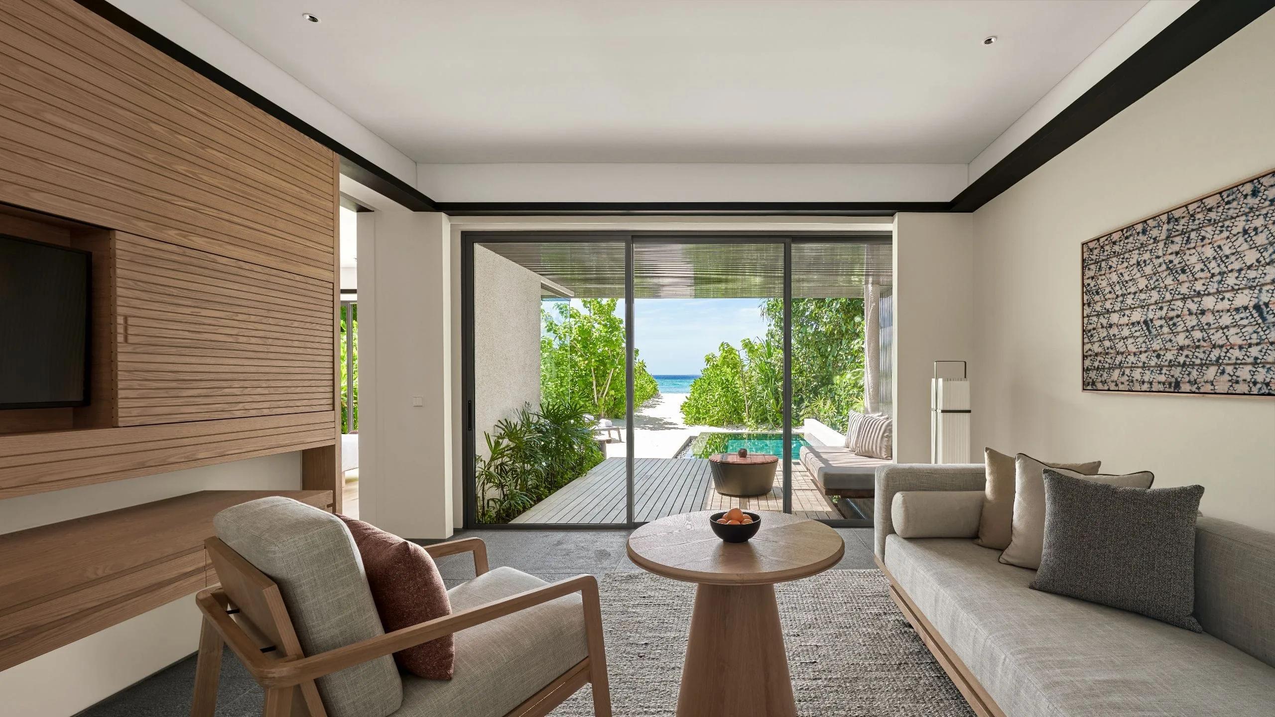 The living area of a Beach Villa, sliding doors open toward the garden