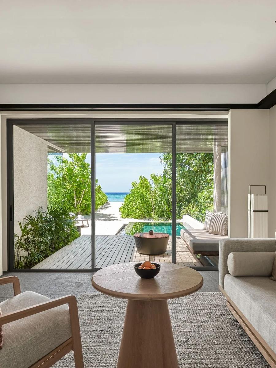 The living area of a Beach Villa, sliding doors open toward the garden