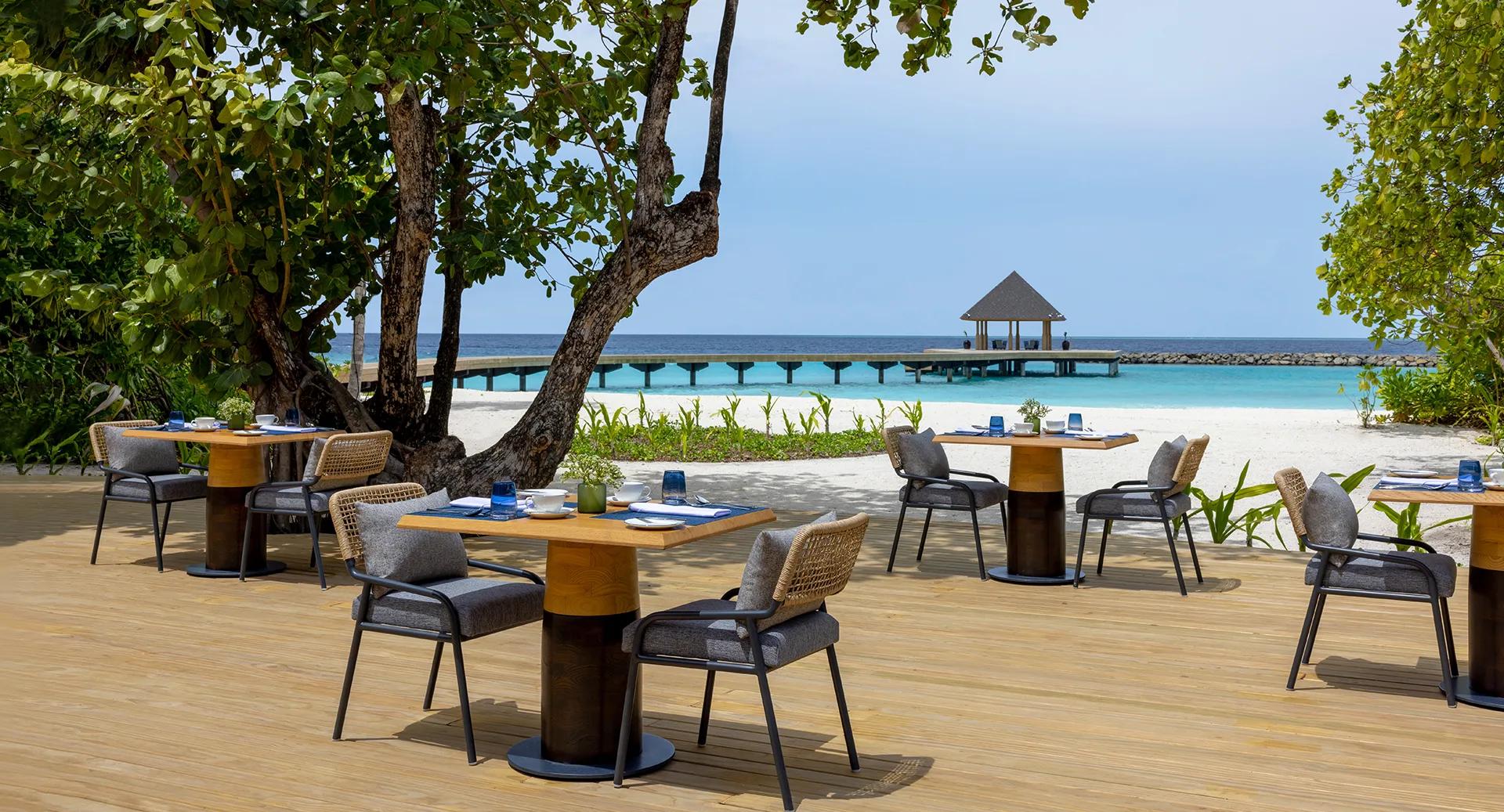 The open-air deck at Ocean Terrace, Avani+ Fares Maldives Resort's main buffet restaurant