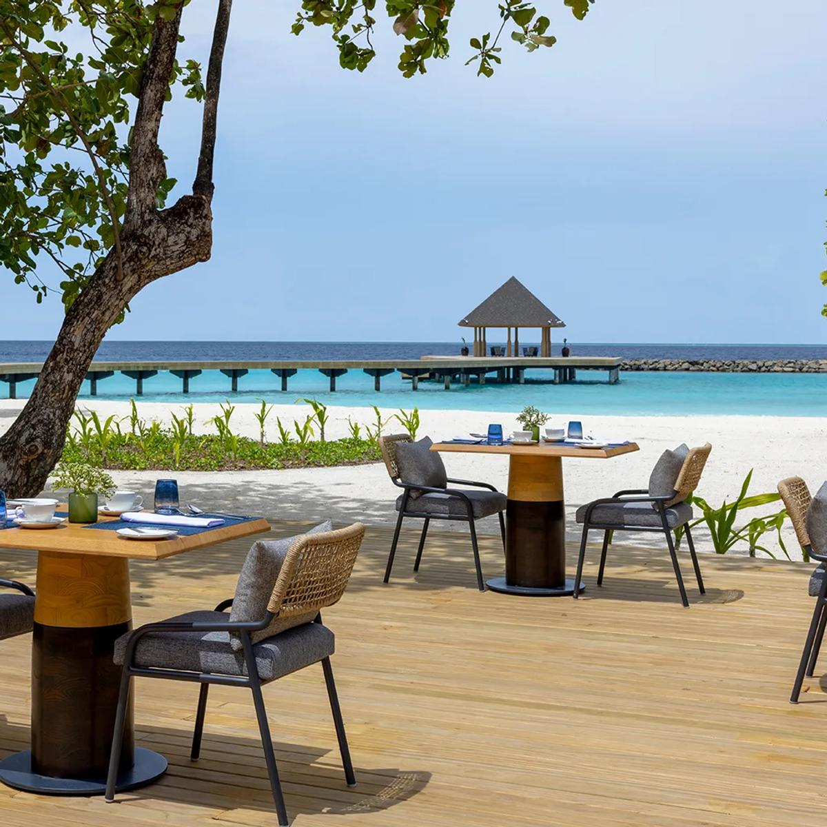 The open-air deck at Ocean Terrace, Avani+ Fares Maldives Resort's main buffet restaurant