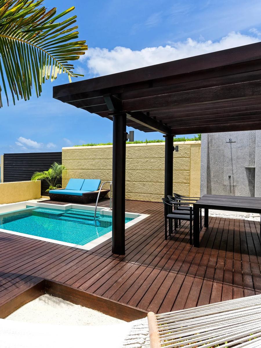 Ocean Villa's private plunge pool and sun deck, with a hammock and direct ocean views over the reef break