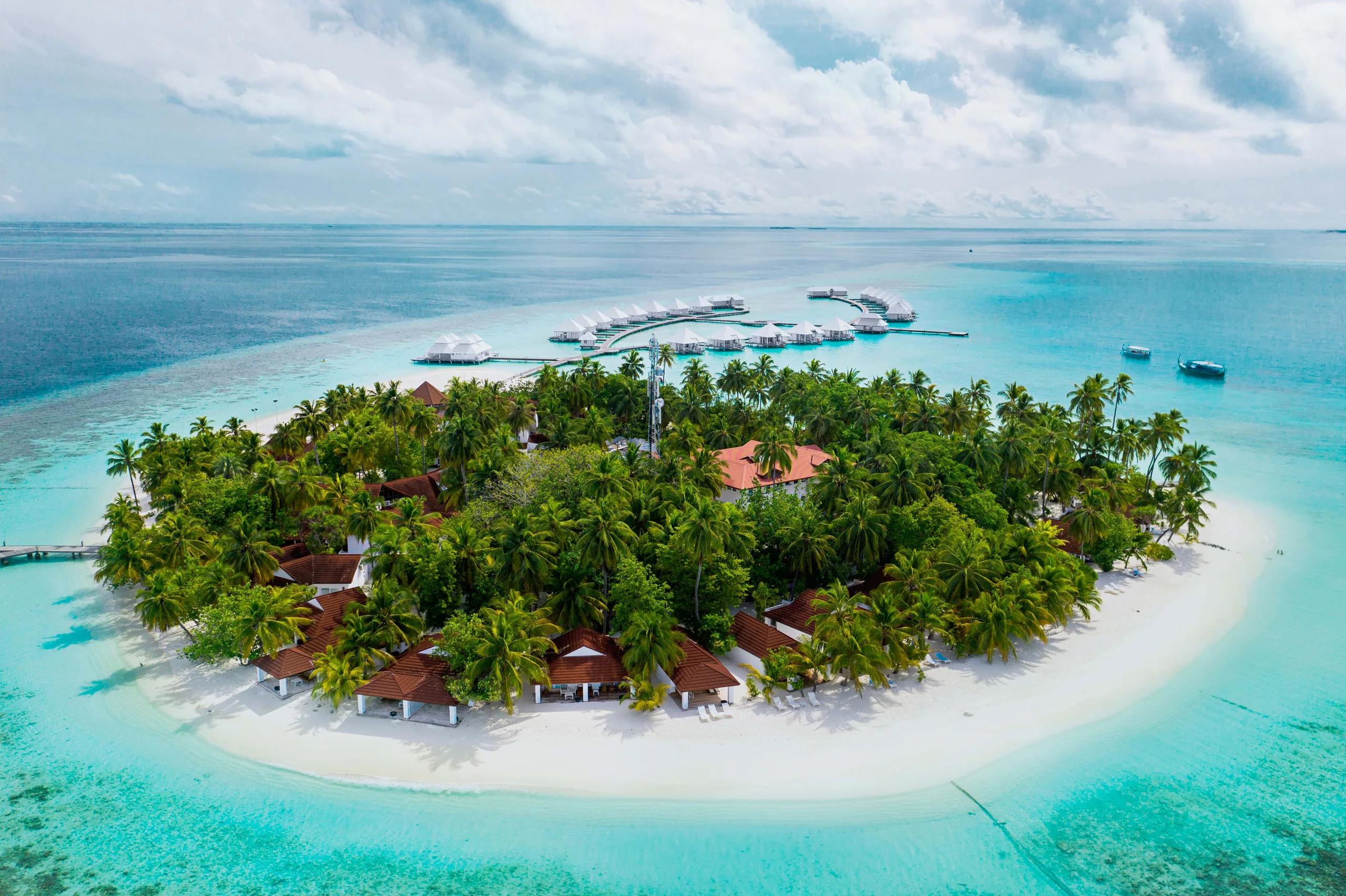 Aerial view of Diamonds Athuruga's island, beach villas and water villa jetties