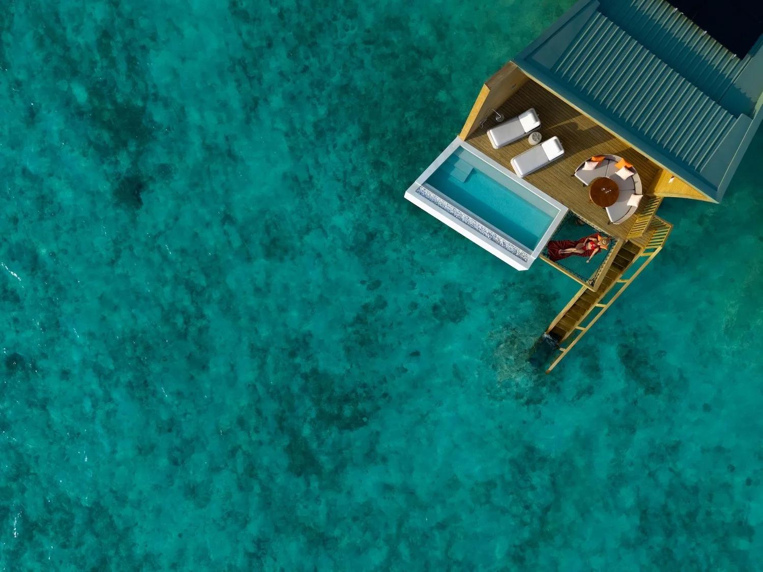 Aerial view of Centara Mirage Lagoon Maldives, overwater villas and the lagoon shared with its sister resort under The Atollia