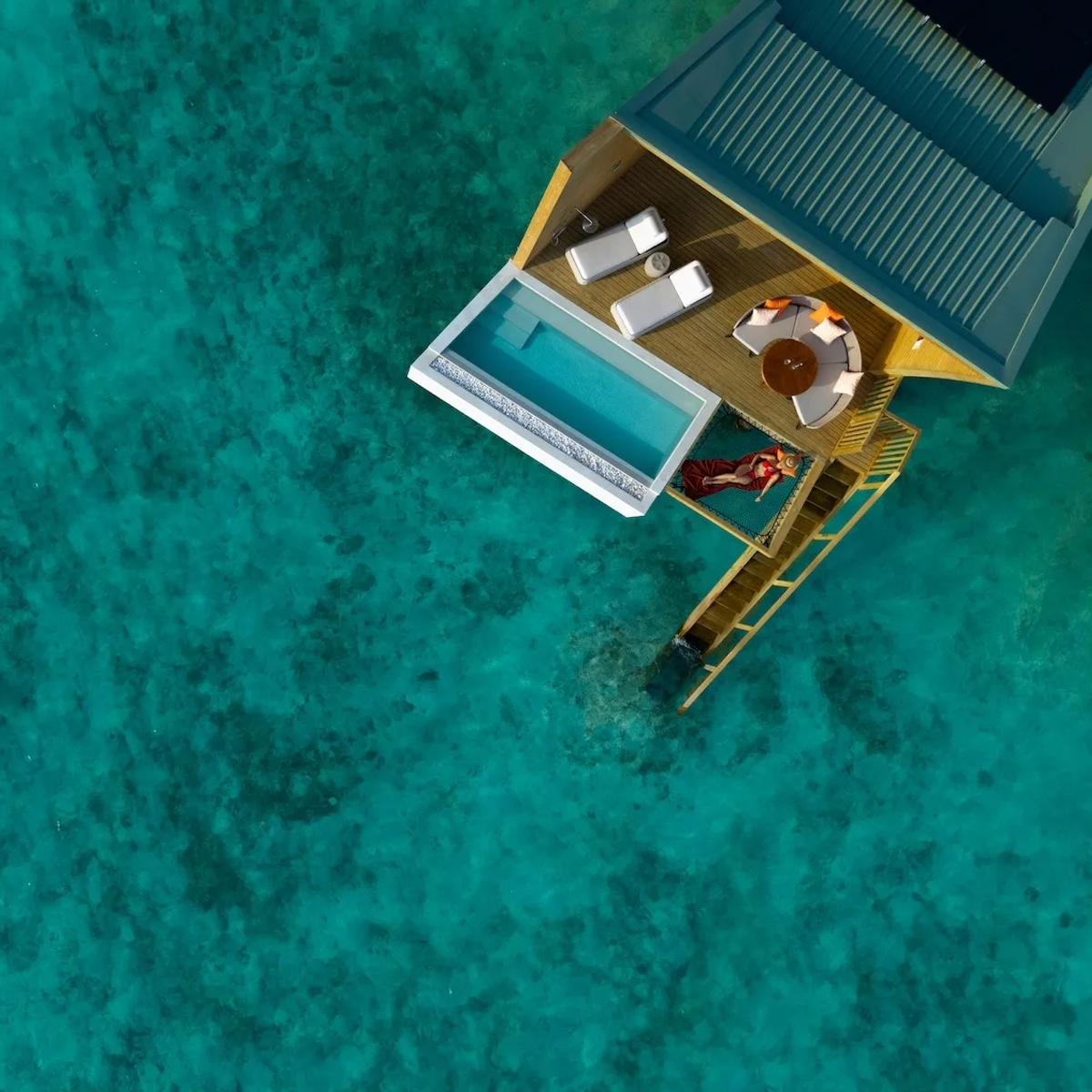 Aerial view of Centara Mirage Lagoon Maldives, overwater villas and the lagoon shared with its sister resort under The Atollia
