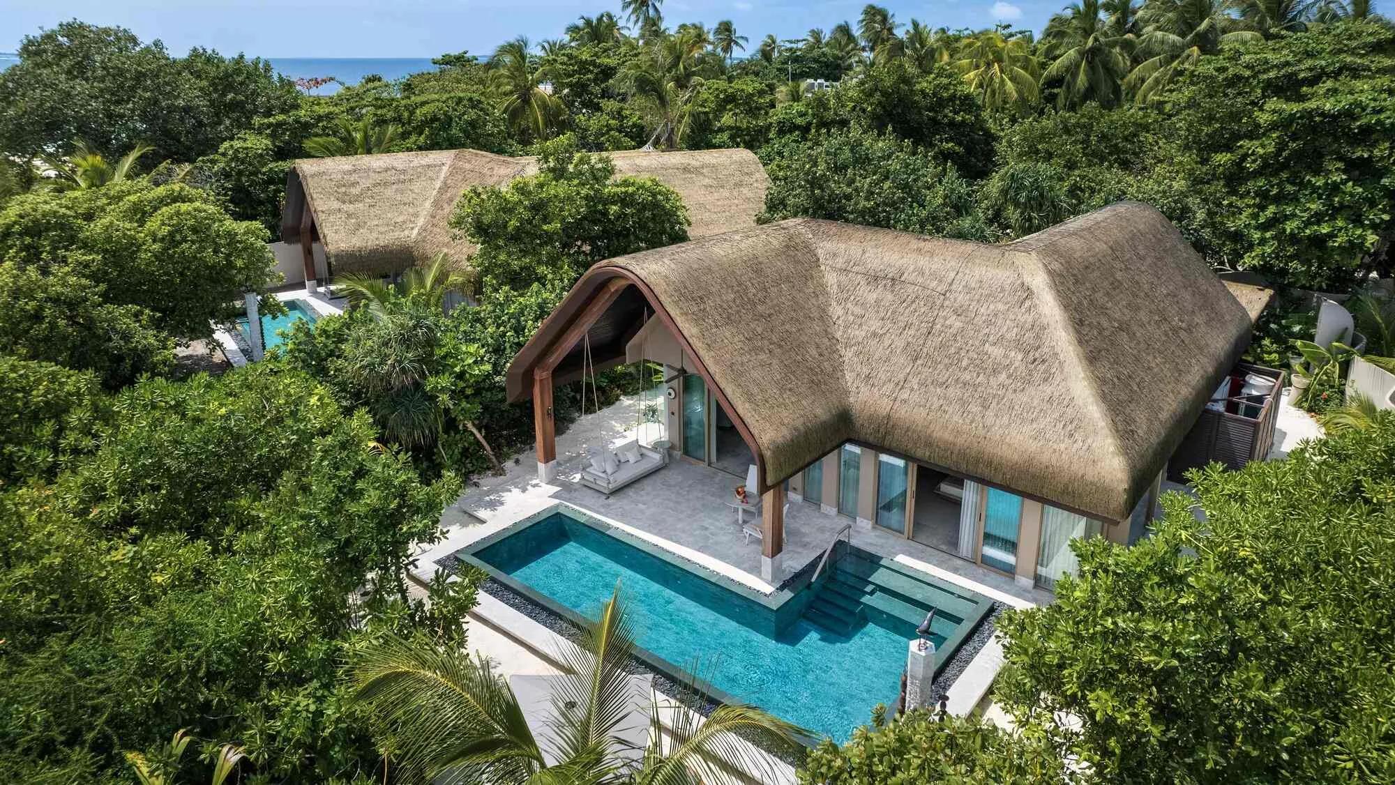 Aerial view of a Grand Beach Pool Villa at Joali Being, showing its toes-in-the-sand position on the beach