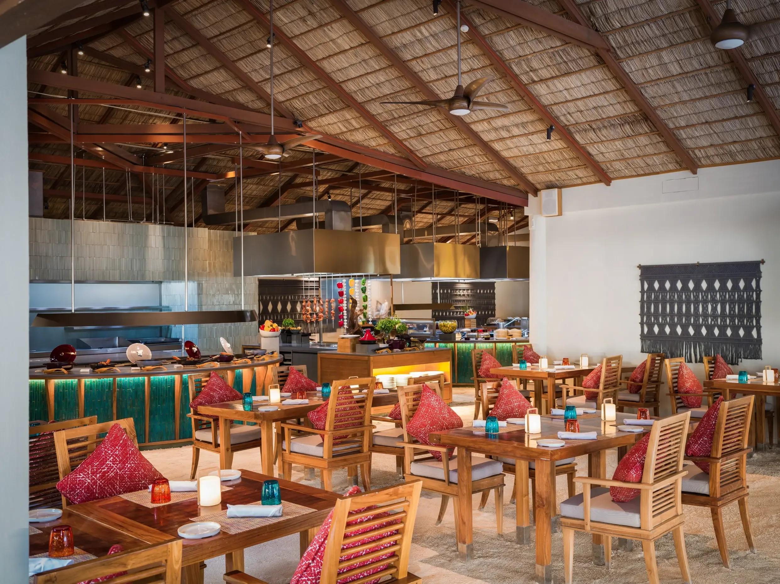 The open kitchen and live cooking stations inside Atoll Market at Conrad Maldives Rangali