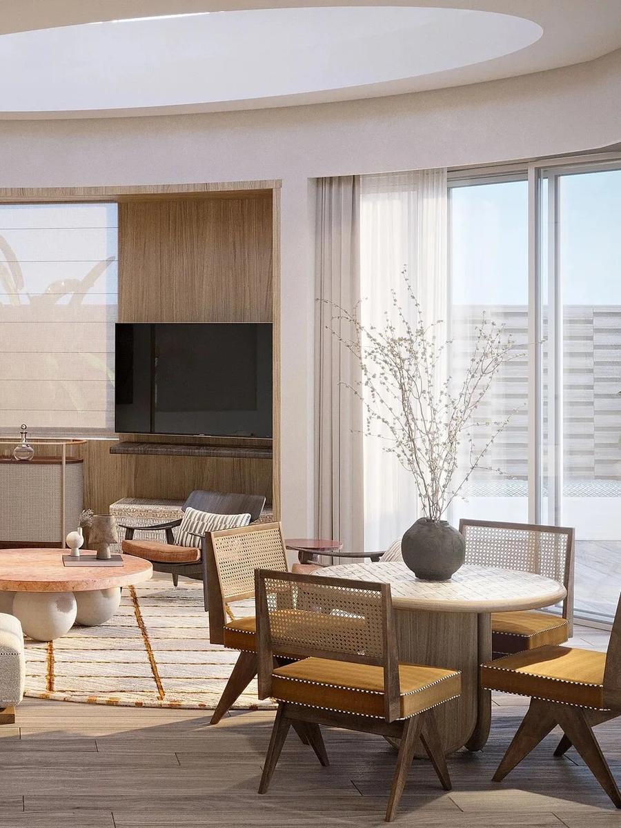 The living area of a One Bedroom Grand Lagoon Villa at Jumeirah Olhahali, with a curved skylight, wet bar and dining nook