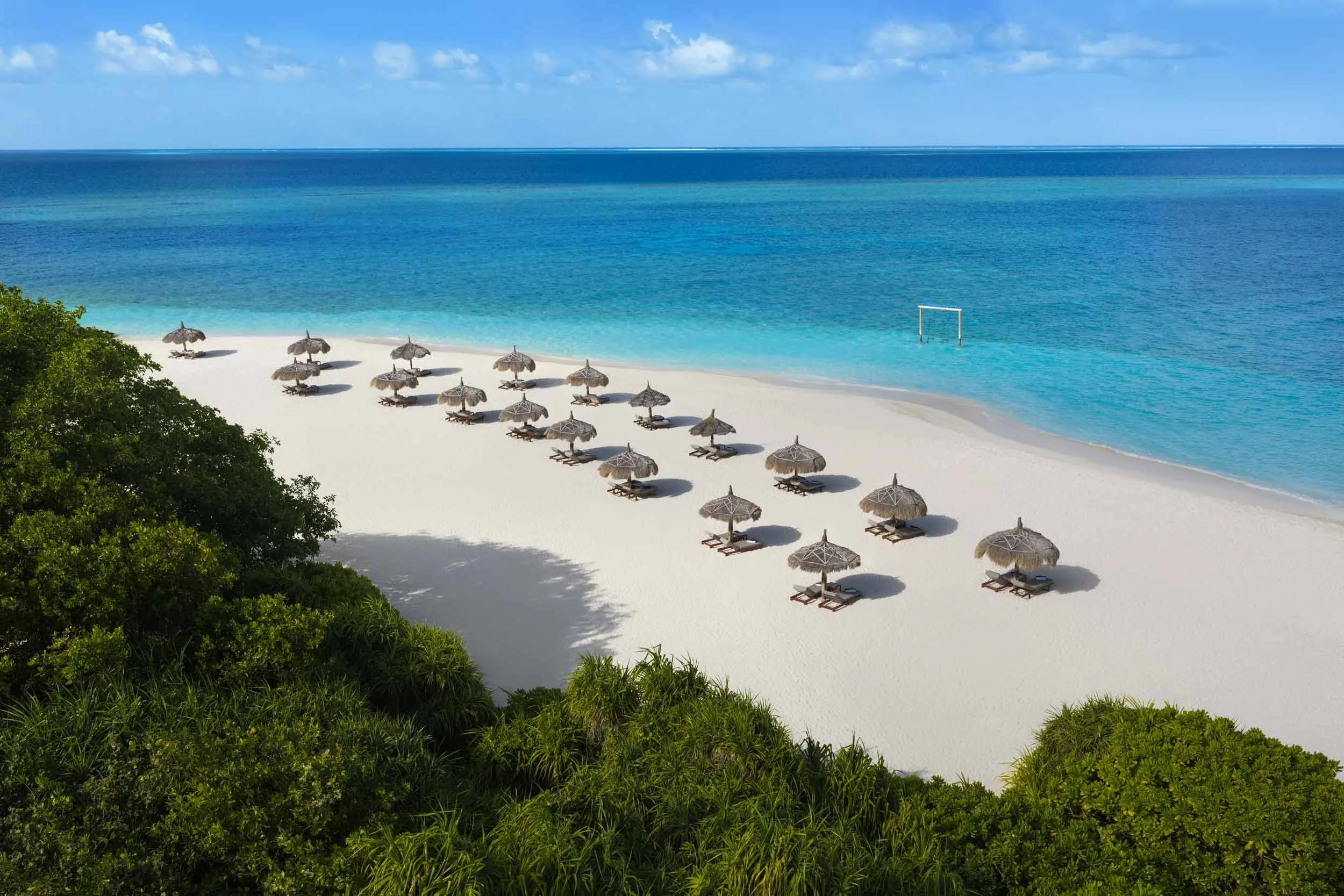 Emerald Maldives' 20-hectare island seen from above, its 1.5 km beach curving around the lagoon