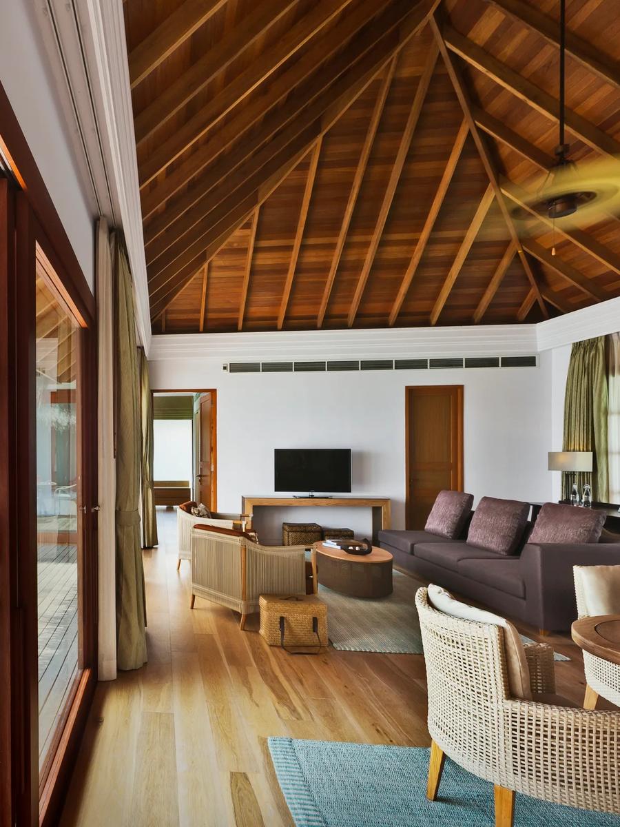 The open-plan living room and overwater deck of a Two Bedrooms Overwater Pool Pavilion at Dusit Thani Maldives