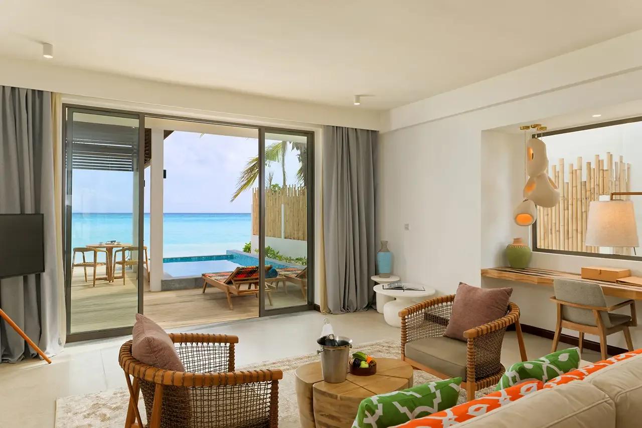A Beach Pool Suite's bedroom opening onto its terrace and plunge pool