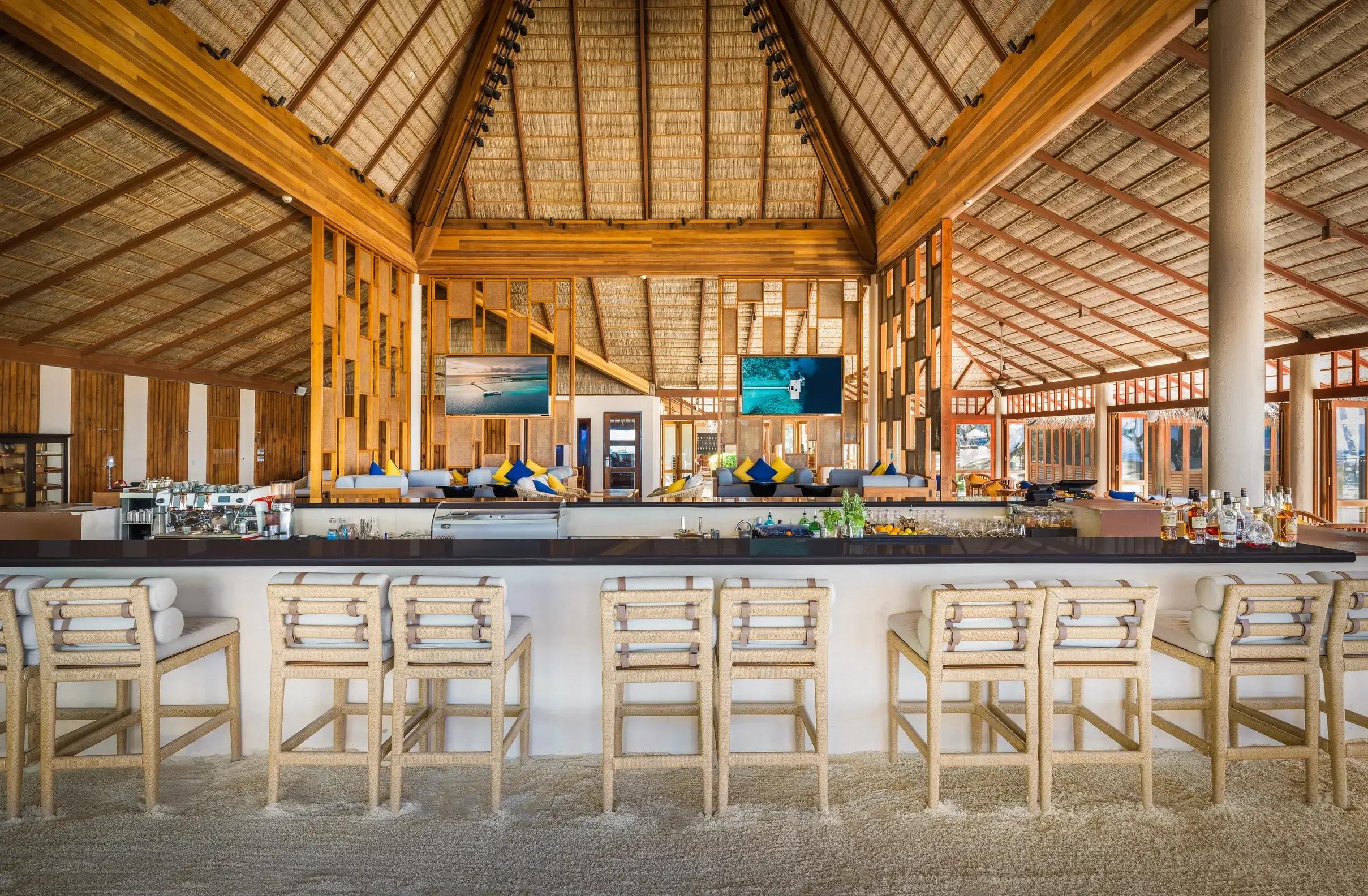 The open-air bar at Rangali Bar, sand floor and thatched roof, at Conrad Maldives Rangali