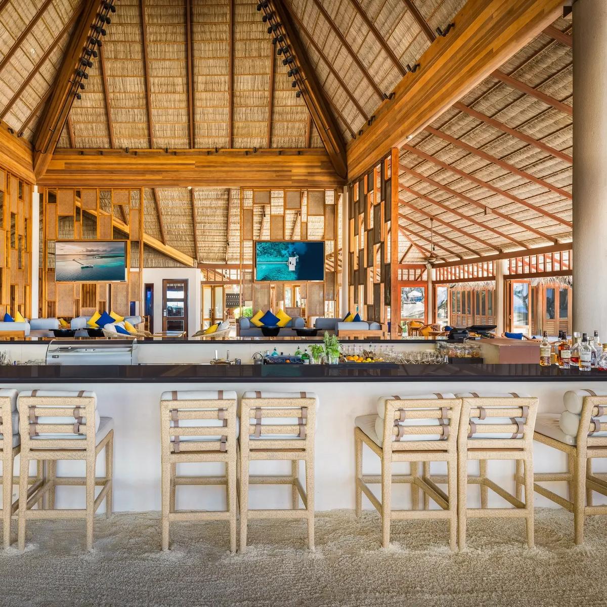 The open-air bar at Rangali Bar, sand floor and thatched roof, at Conrad Maldives Rangali