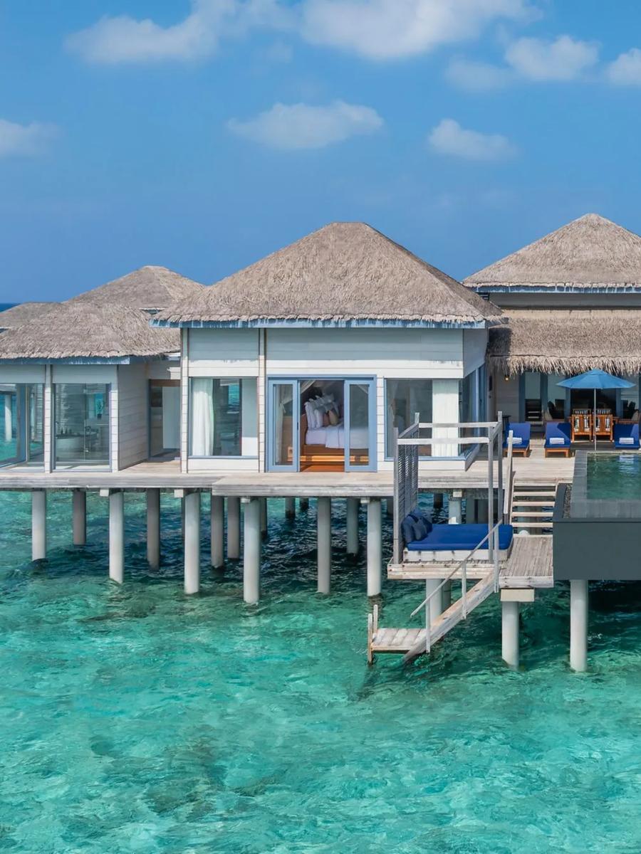A Two-Bedroom Villa seen from above, its infinity pool reaching toward the lagoon