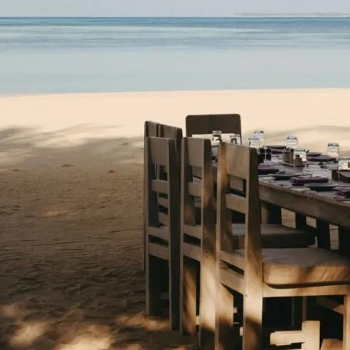 Toes-in-the-sand tables at Crab Shack, Soneva Jani's seafood restaurant at the water's edge