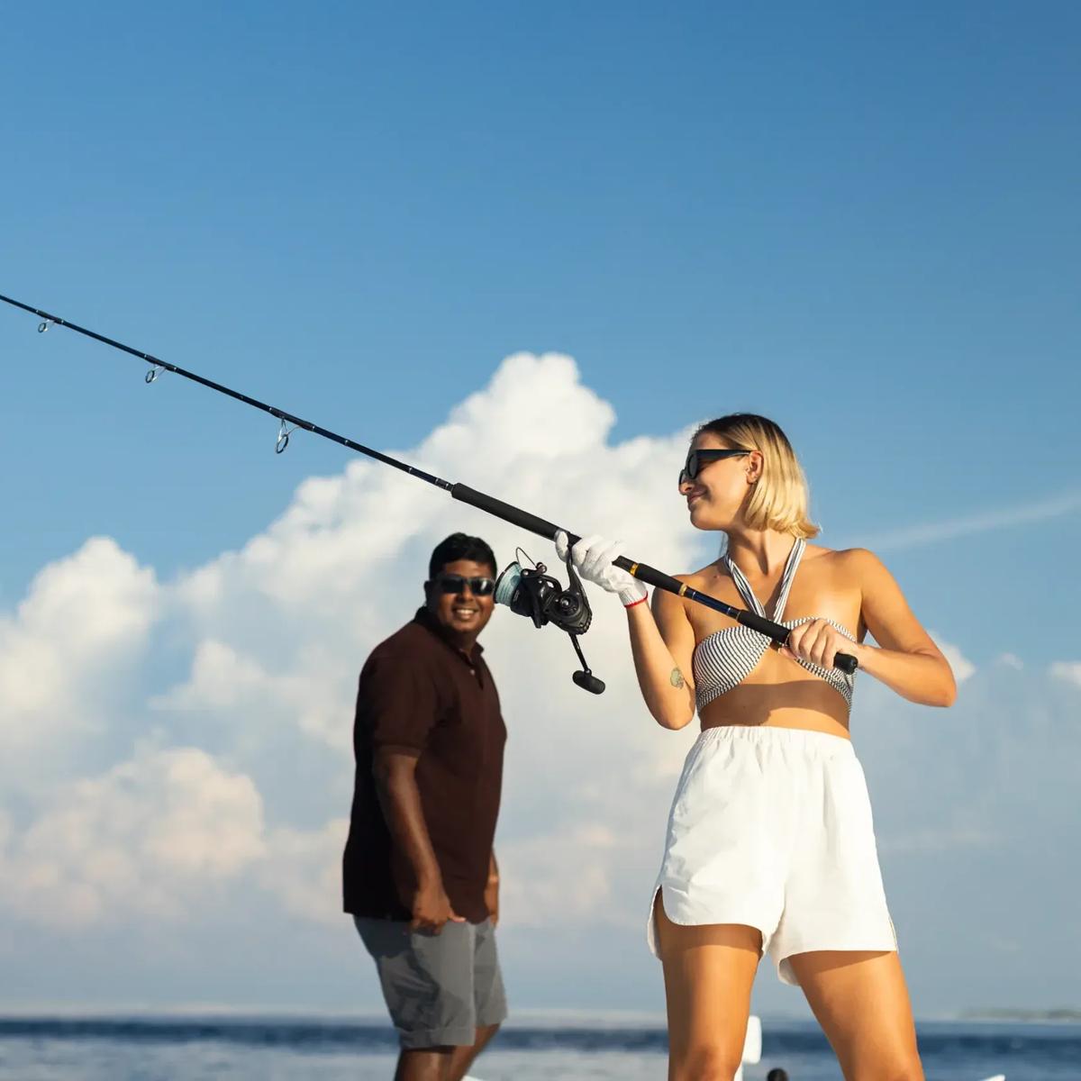 A guest big-game fishing from a charter boat off a Maldives resort