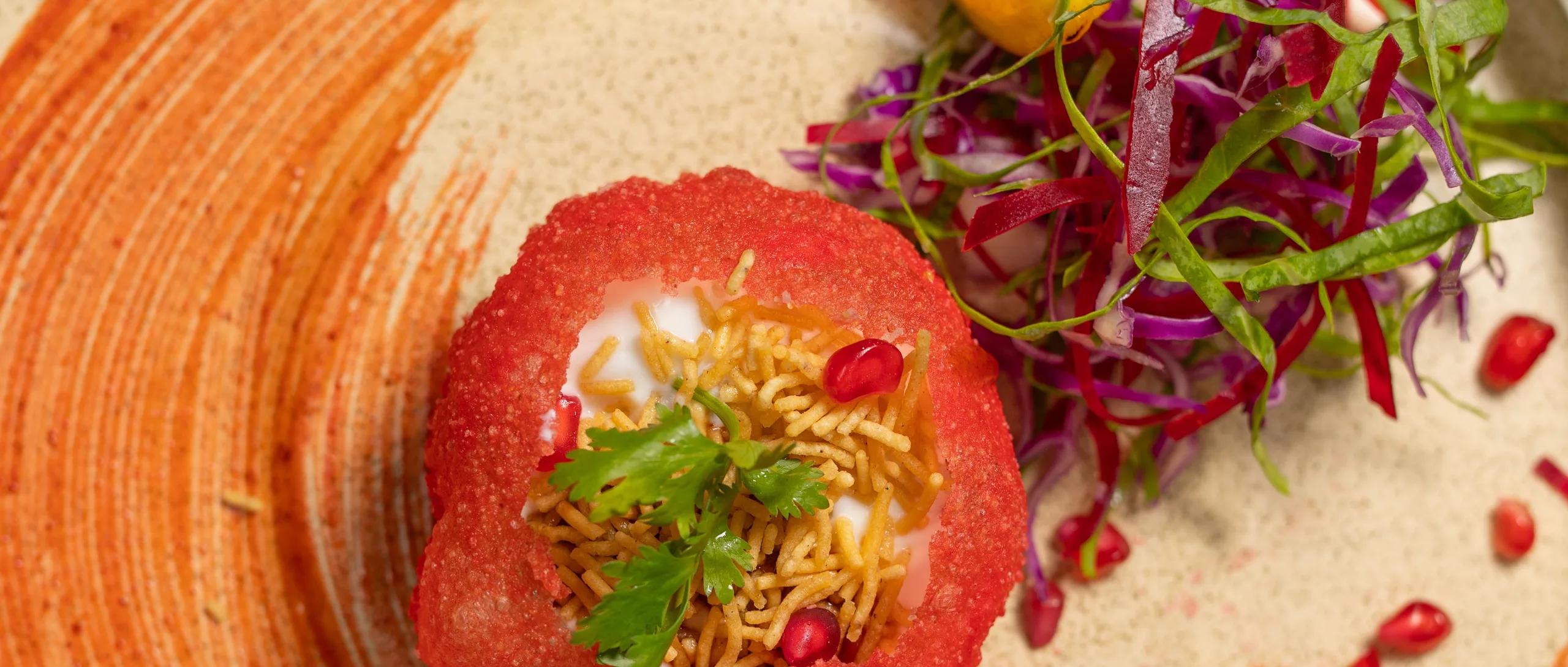 A chef prepares a dish in Just Veg's kitchen