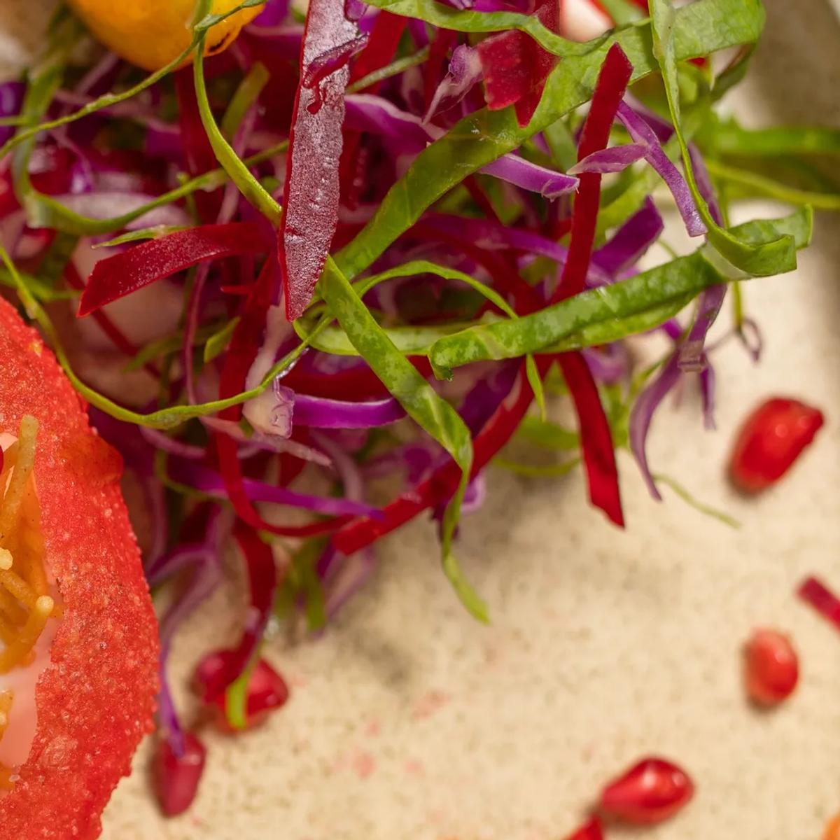 A chef prepares a dish in Just Veg's kitchen