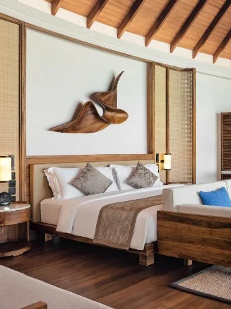 Bedroom interior of a Sunset Over Water Suite at Anantara Dhigu