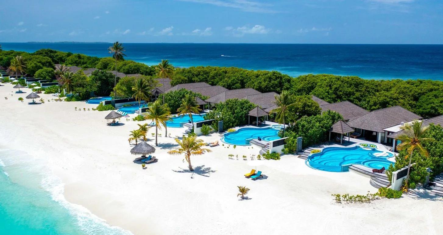 An aerial view along Atmosphere Kanifushi's beachfront pool villas, including the resort's largest private-pool categories