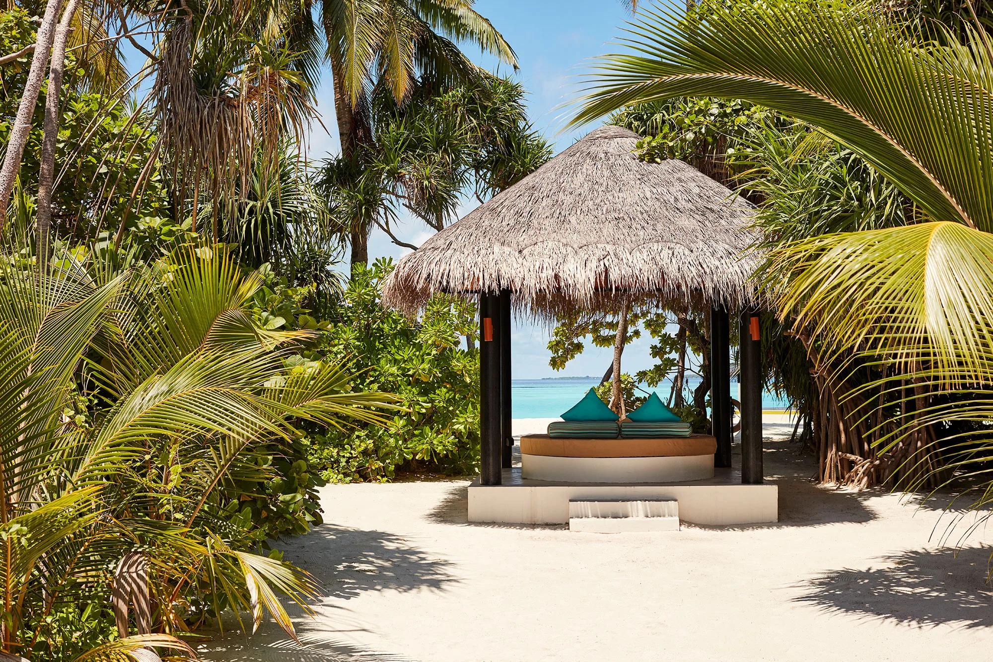 A thatched beach sala open to a private pool deck, representative of Iru Fushi's private-pool beach villas — dedicated Private Pool Beach Villa photography to follow