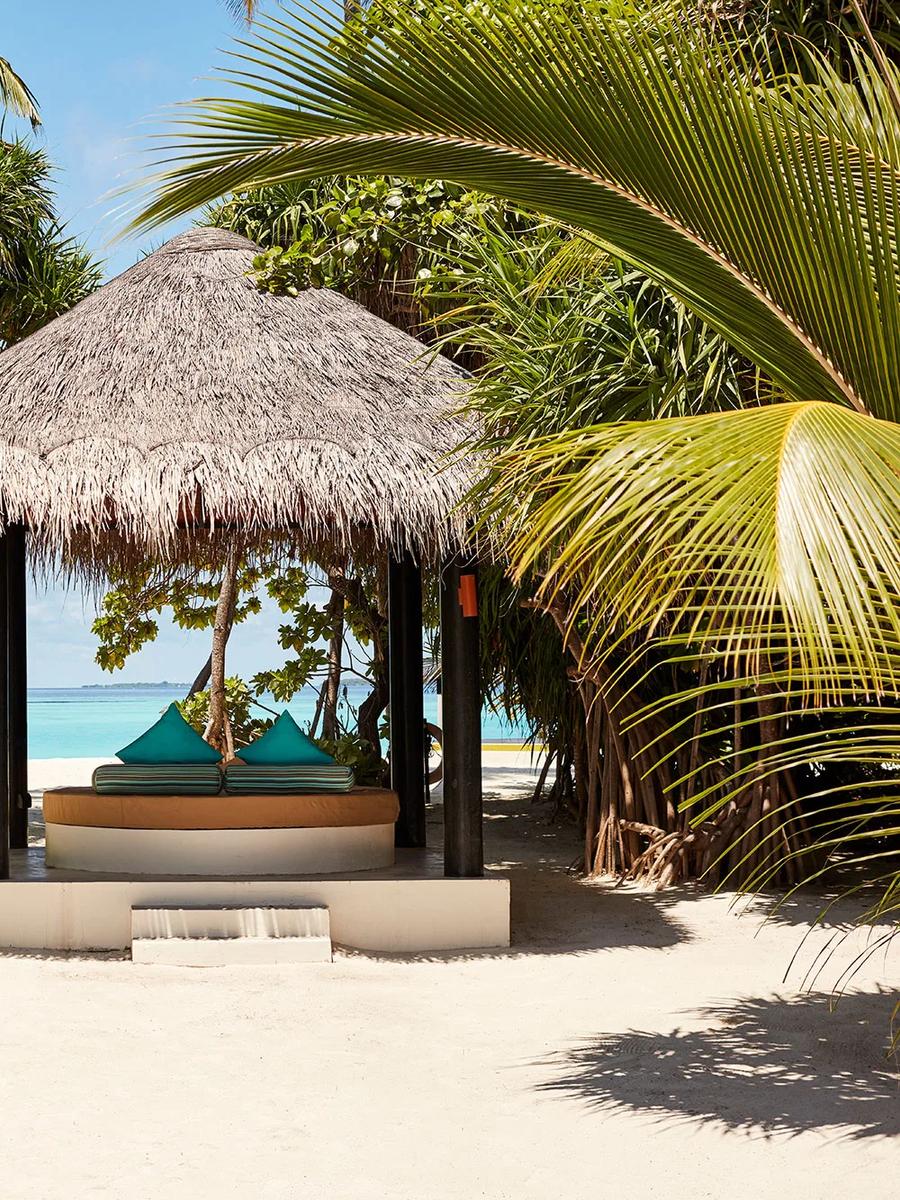A thatched beach sala open to a private pool deck, representative of Iru Fushi's private-pool beach villas — dedicated Private Pool Beach Villa photography to follow