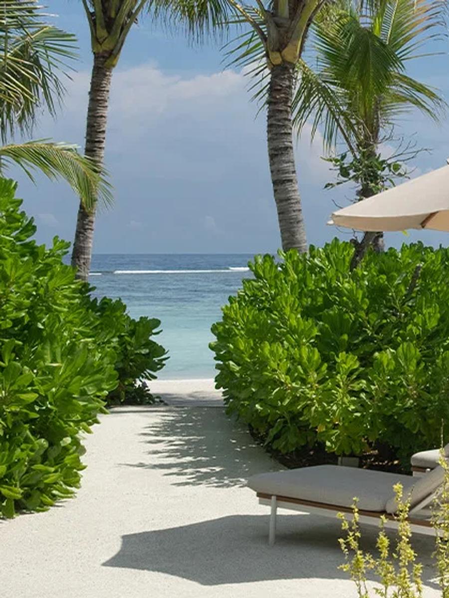 A sandy path lined with hibiscus and palms leading from a beach villa's pool deck to the shore at SO/ Maldives — representative of the Beach Pool Villa category; a dedicated single-villa photograph was not available
